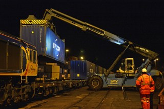 Containers are loaded onto the train ready for its return to Birch Coppice. 