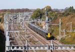 A view looking down on a Great Western Railway Class 387 with overhead line equipment in the foreground.