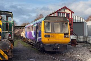 An ex-Northern Pacer stands alongside the signal box in the CF Booth scrapyard in Rotherham