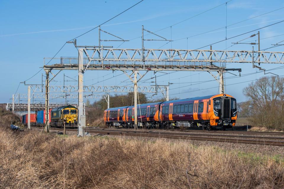 Paths are in short supply on the heavily used mixed-traffic West Coast Main Line. At Great Bridgford (Staffordshire) on January 26 2022, West Midlands Railway 730005 works along the West Coast Main Line on test as part of the fleet’s introduction to service, while Freightliner 66520 works an intermodal service. JACK BOSKETT.