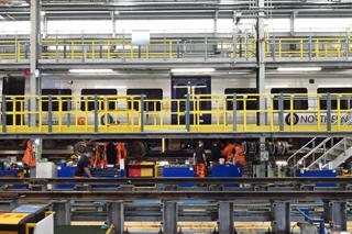 Staff work on 195110 inside St Mary’s shed. The walkways at Solebar and roof height allow easy access to the interior and rooftop HVAC modules. PAUL BIGLAND