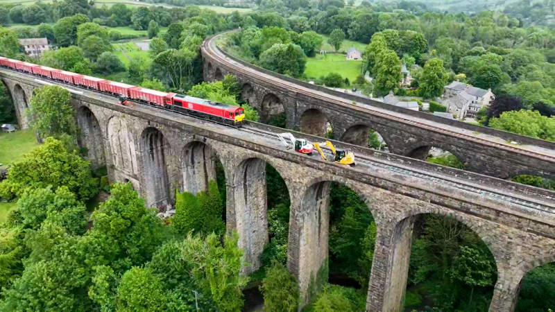 A DB Cargo UK Class 66 on Chapel Milton Viaduct with a train of empty box wagons for the quarries near Buxton. NETWORK RAIL.