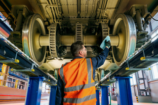 Man cleaning rail equipment 