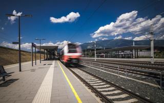 A train passes through St. Paul train station in the Lavant Valley on the Koralmbahn in Austria. 