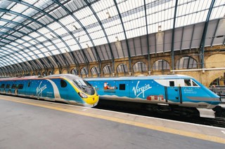 'Penguilino' 390013 at King's Cross on December 1, alongside the 'Claus91' train, featuring Driving Van Trailer 82209. VIRGIN TRAINS.
