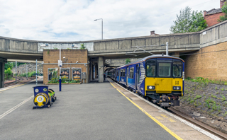 ScotRail 318268 arrives at Exhibition Centre station on July 15 2019. ALAMY.
