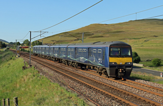 Varamis Rail 321334 heads south on the West Coast Main Line at Wandel Mill (north of Abington) with the 1818 Mossend to Birmingham International parcels train on June 15 2023. The operator has now suspended services until September. STUART FOWLER.