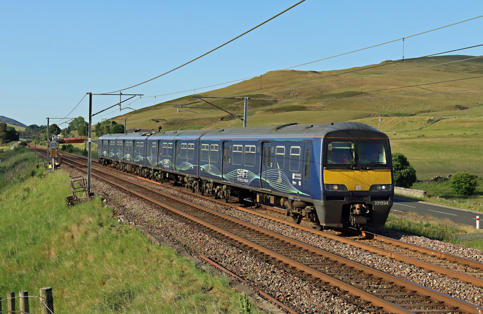 Varamis Rail 321334 heads south on the West Coast Main Line at Wandel Mill (north of Abington) with the 1818 Mossend to Birmingham International parcels train on June 15 2023. The operator has now suspended services until September. STUART FOWLER.