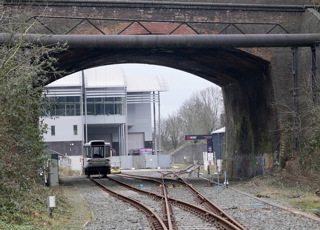 Looking through the old railway bridge at Very Light Rail National Innovation Centre building in Dudley. Parry People Mover's Railcar 10 is seen stored under the bridge. PETER PLISNER.