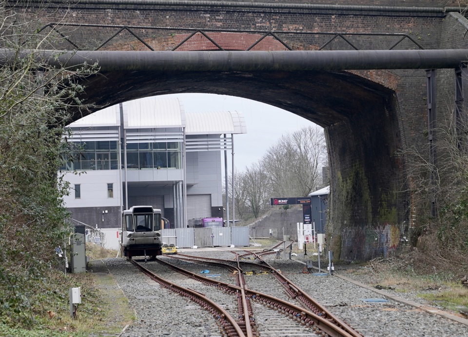 Looking through the old railway bridge at Very Light Rail National Innovation Centre building in Dudley. Parry People Mover's Railcar 10 is seen stored under the bridge. PETER PLISNER.
